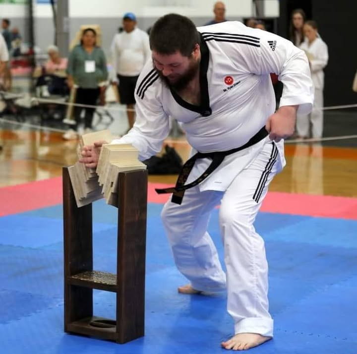 Ryan Dillard at a taekwondo board-breaking demonstration